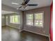 Open living room area with ceiling fan, hardwood floors, and neutral paint provides cozy comfort at 4852 Pine Shadows Dr, Stone Mountain, GA 30088