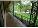 Cozy front porch features ornate iron railings, offering scenic views of the landscaped yard at 4852 Pine Shadows Dr, Stone Mountain, GA 30088
