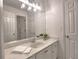 Bathroom vanity with bright light fixture, white cabinets and granite countertop at 750 Whitehall Way, Roswell, GA 30076