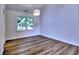 This dining room features wood floors, a large window, and a modern light fixture at 750 Whitehall Way, Roswell, GA 30076