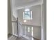 Staircase with large window letting in natural light into the home's foyer at 750 Whitehall Way, Roswell, GA 30076