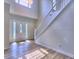 Bright foyer with hardwood floors, staircase, and decorative front door with sidelights allowing for lots of natural light at 750 Whitehall Way, Roswell, GA 30076