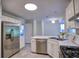Open kitchen with stainless steel appliances, tile floors, and an adjoining area at 750 Whitehall Way, Roswell, GA 30076