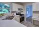 Kitchen features stainless steel appliances, white cabinets, and a view to the backyard at 750 Whitehall Way, Roswell, GA 30076