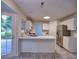Spacious white kitchen with tile floors, stainless steel refrigerator, and plenty of counter space at 750 Whitehall Way, Roswell, GA 30076