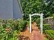 Beautiful landscaping featuring a pathway through an archway at 750 Whitehall Way, Roswell, GA 30076