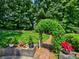 Manicured landscaping with flowerbeds and a vine-covered pergola at 750 Whitehall Way, Roswell, GA 30076