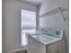 Convenient laundry room with a window and storage shelf at 750 Whitehall Way, Roswell, GA 30076