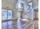 Open-concept living room featuring hardwood floors, a staircase, and large windows for ample light at 750 Whitehall Way, Roswell, GA 30076