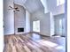 This home's living room boasts a tall, vaulted ceiling, a charming brick fireplace, and hardwood floors at 750 Whitehall Way, Roswell, GA 30076