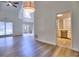 Spacious living room with hardwood floors, high ceilings, and an open doorway to the kitchen at 750 Whitehall Way, Roswell, GA 30076