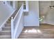 Bright and open living room featuring hardwood floors, a staircase, and vaulted ceilings at 750 Whitehall Way, Roswell, GA 30076