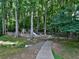 Community playground with slides and play structures nestled among mature trees, offering a fun outdoor experience at 750 Whitehall Way, Roswell, GA 30076