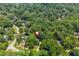 Aerial view of a secluded neighborhood with mature trees, winding roads, and beautiful homes offering a peaceful living environment at 799 Birds Se Ml, Marietta, GA 30067