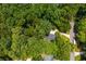 An aerial view of a home nestled among lush green trees, showcasing a private and serene setting with mature landscaping at 799 Birds Se Ml, Marietta, GA 30067