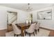 Bright dining room featuring a modern chandelier, art, and an opening to the stairwell at 799 Birds Se Ml, Marietta, GA 30067