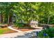 Traditional home featuring an attached garage, manicured landscaping, and a winding sidewalk leading to the front door at 799 Birds Se Ml, Marietta, GA 30067