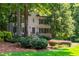 Charming two-story home with a manicured lawn, lush landscaping, and a welcoming entrance with a black front door at 799 Birds Se Ml, Marietta, GA 30067