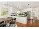 Bright kitchen with white cabinets, stainless steel appliances, black countertops, and hardwood floors at 799 Birds Se Ml, Marietta, GA 30067
