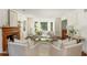 Elegant living room with neutral decor, fireplace, hardwood floors, and plenty of natural light at 799 Birds Se Ml, Marietta, GA 30067