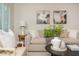 Bright living room with neutral decor, modern artwork, and ample natural light from window with shutters at 799 Birds Se Ml, Marietta, GA 30067