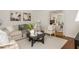 Cozy living room features neutral tones, wood floors, and a glimpse into another room through an open doorway at 799 Birds Se Ml, Marietta, GA 30067