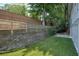 Backyard features a retaining wall, small patio and artificial turf for a low maintenance yard at 1971 Wellesley Trce, Dunwoody, GA 30338