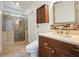 Bathroom featuring a glass shower with decorative tile and stylish vanity at 1971 Wellesley Trce, Dunwoody, GA 30338