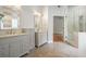Bathroom boasting double vanity, tiled flooring, and glass shower door at 1971 Wellesley Trce, Dunwoody, GA 30338
