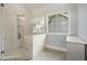 Bathroom featuring a glass enclosed shower with modern shower head, window, and vanity at 1971 Wellesley Trce, Dunwoody, GA 30338