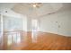 Large bedroom with tray ceiling and hardwood floors leading to another room at 1971 Wellesley Trce, Dunwoody, GA 30338