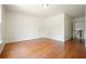 Spacious bedroom with wood floors, white walls, and a white door at 1971 Wellesley Trce, Dunwoody, GA 30338