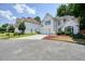 Inviting stucco house featuring a two-car garage, street view, and attractive landscaping at 1971 Wellesley Trce, Dunwoody, GA 30338