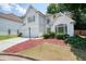 Stucco house with a two-car garage, pretty landscaping, and well-maintained lawn at 1971 Wellesley Trce, Dunwoody, GA 30338