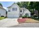 Charming stucco home with a two-car garage, manicured lawn, and inviting curb appeal at 1971 Wellesley Trce, Dunwoody, GA 30338