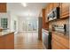 Bright kitchen featuring wood cabinets, granite countertops, and stainless steel appliances at 1971 Wellesley Trce, Dunwoody, GA 30338