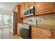 Kitchen with stainless steel appliances and wood cabinets at 1971 Wellesley Trce, Dunwoody, GA 30338