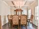 Elegant dining room featuring hardwood floors, coffered ceilings, and a traditional dining set at 2102 Black Pebble Cir, Buford, GA 30519