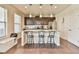 Bright kitchen featuring an island with seating, dark cabinetry, and stainless steel appliances at 2102 Black Pebble Cir, Buford, GA 30519