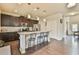 Spacious kitchen with an island, dark cabinetry, stainless steel appliances, and hardwood flooring at 2102 Black Pebble Cir, Buford, GA 30519