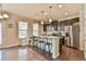 Stylish kitchen featuring a large island with seating, stainless steel appliances, and modern finishes at 2102 Black Pebble Cir, Buford, GA 30519
