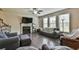 Inviting living room with fireplace, hardwood floors, and large windows allowing ample natural light at 2102 Black Pebble Cir, Buford, GA 30519