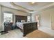 Bright main bedroom with tray ceiling, carpet flooring and ensuite bathroom access at 2102 Black Pebble Cir, Buford, GA 30519
