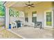 Covered patio space with a ceiling fan and room for grilling at 2102 Black Pebble Cir, Buford, GA 30519