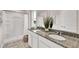 Modern bathroom with double sinks, granite countertops, tiled floors, and a walk-in shower at 5453 Baybrook Cir, South Fulton, GA 30349