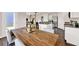 Dining area with a rustic wood table, comfortable seating and stylish lighting adjacent to the kitchen at 5453 Baybrook Cir, South Fulton, GA 30349