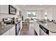 Modern kitchen with stainless steel appliances, granite counters, and a large island with seating area at 5453 Baybrook Cir, South Fulton, GA 30349