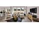 Spacious living room with comfortable sectional, large windows, and modern decor leading to a kitchen at 5453 Baybrook Cir, South Fulton, GA 30349
