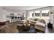 Bright and airy living room featuring large windows, hardwood floors, and a comfortable sectional sofa at 5453 Baybrook Cir, South Fulton, GA 30349