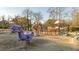 Outdoor playground featuring slides, play equipment, and a dinosaur spring rider for Gathering fun at 5453 Baybrook Cir, South Fulton, GA 30349